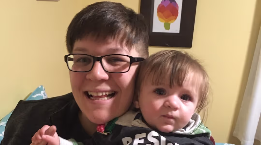 Ryan Ambuter and a baby posing for a picture