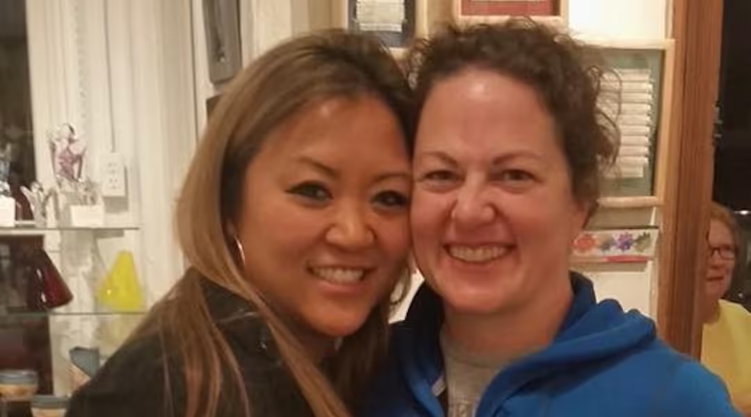 Amanda Town Welch and her wife posing for a photo in Womencrafts