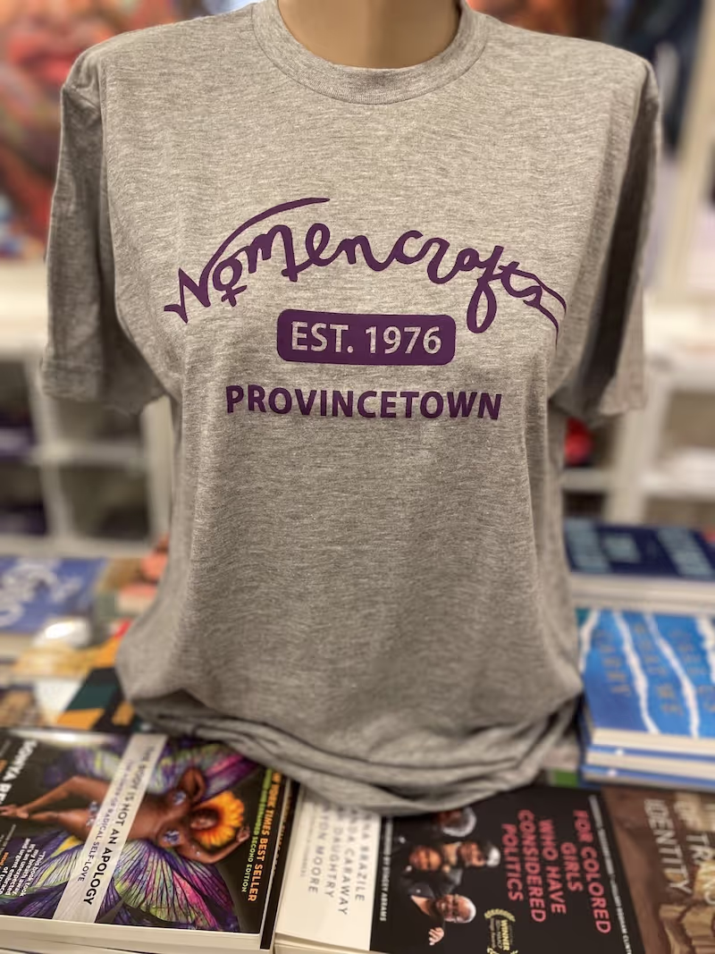 Gray t-shirt with purple graphics promoting Womencrafts in Provincetown, MA