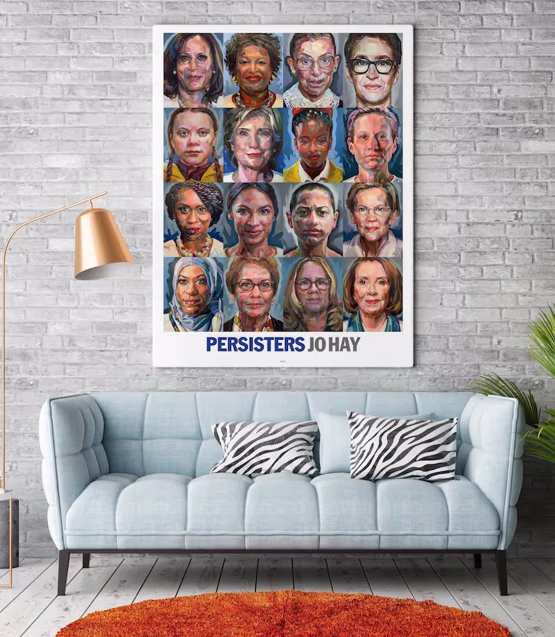 The Persisters Poster by Jo Hay hung on a white brick wall above a modern blue sofa