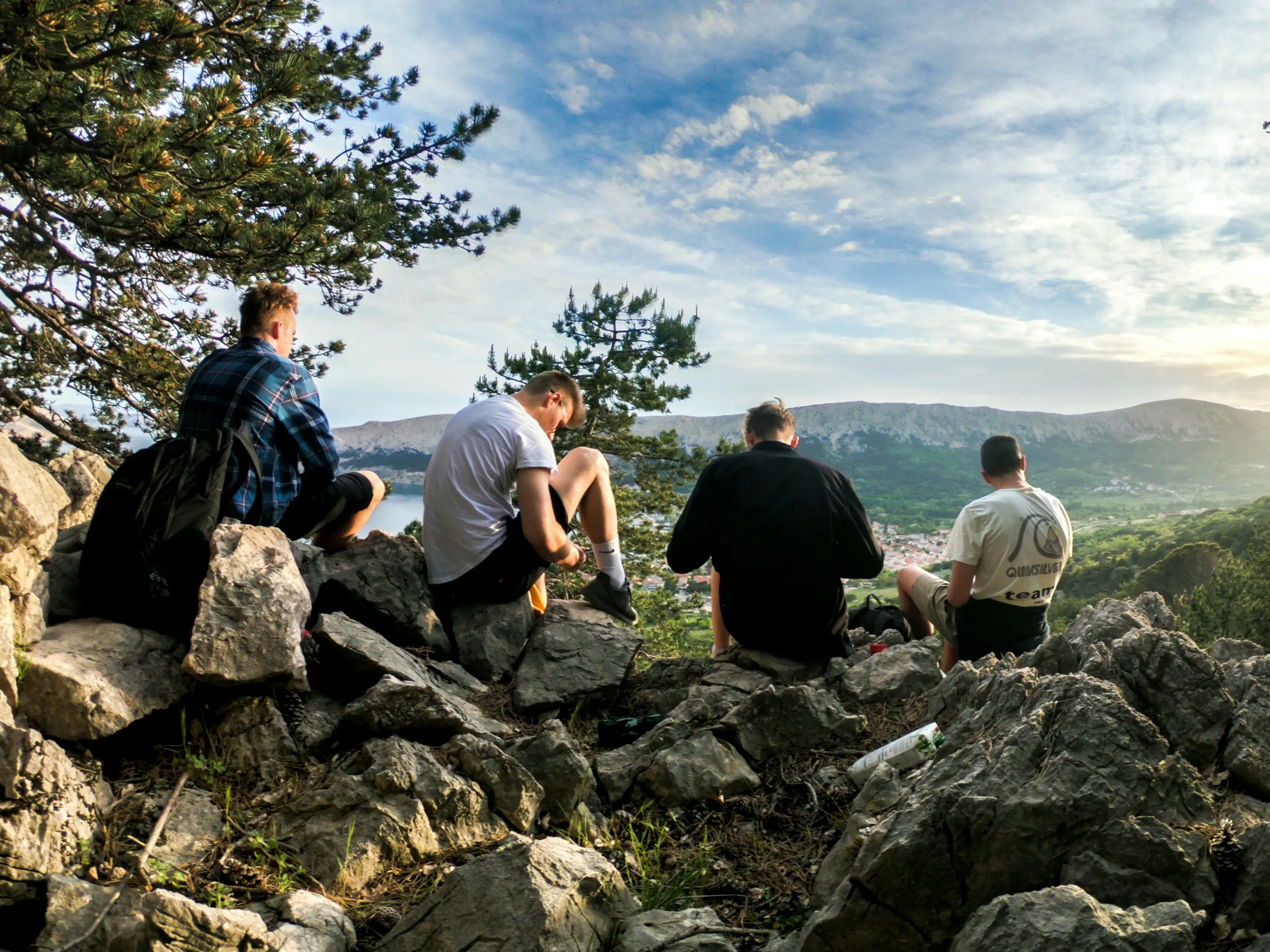 group of men sitting in a circle on green grass