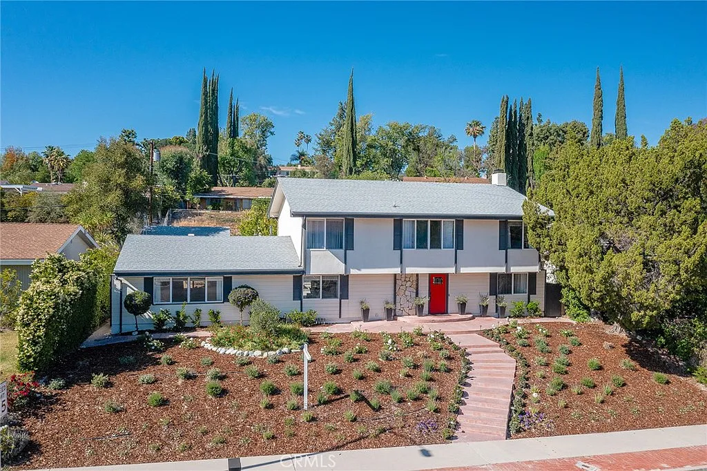 exterior of a home with a white picket fence