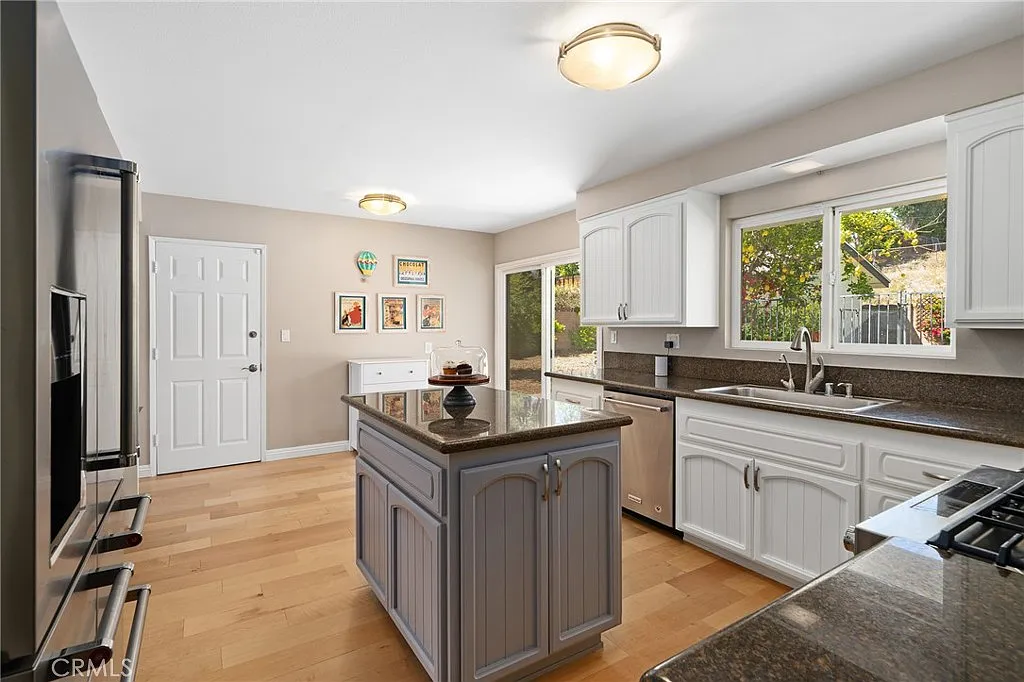 interior of a kitchen with cabinets and a microwave