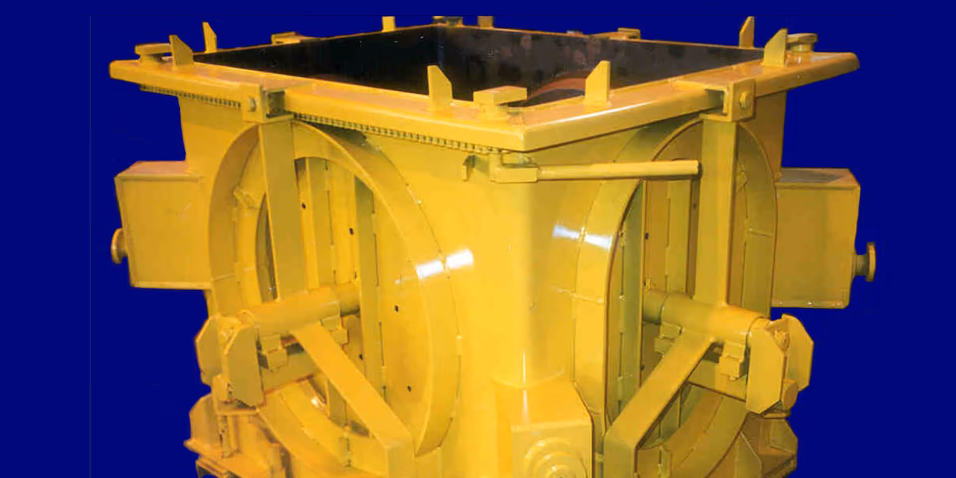 Yellow industrial metal container with reinforced sides and hinges, set against a solid blue background.