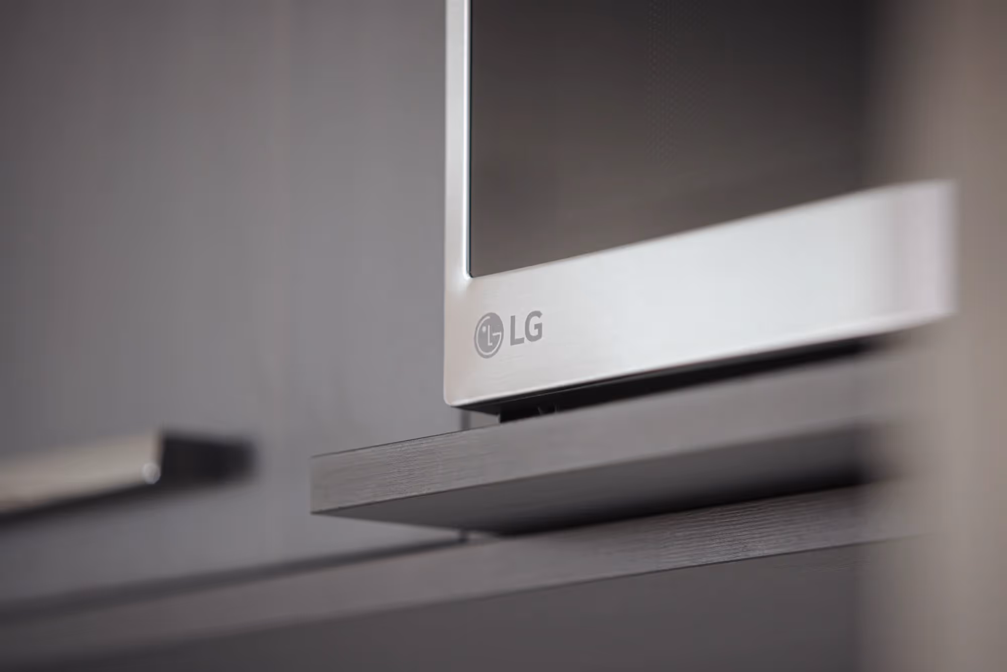 Detail shot of an LG brand microwave in an apartment at The Julian in Sloans Lake, Denver, showcasing modern appliances.