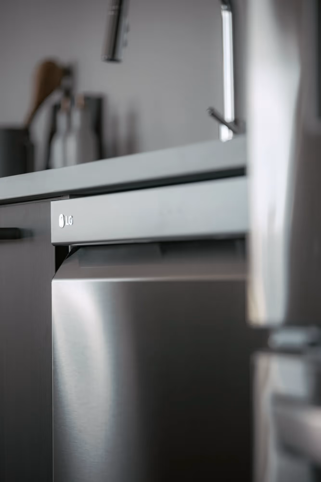 Close-up of a stainless steel LG dishwasher in a modern kitchen at The Julian apartments, highlighting high-end appliances.