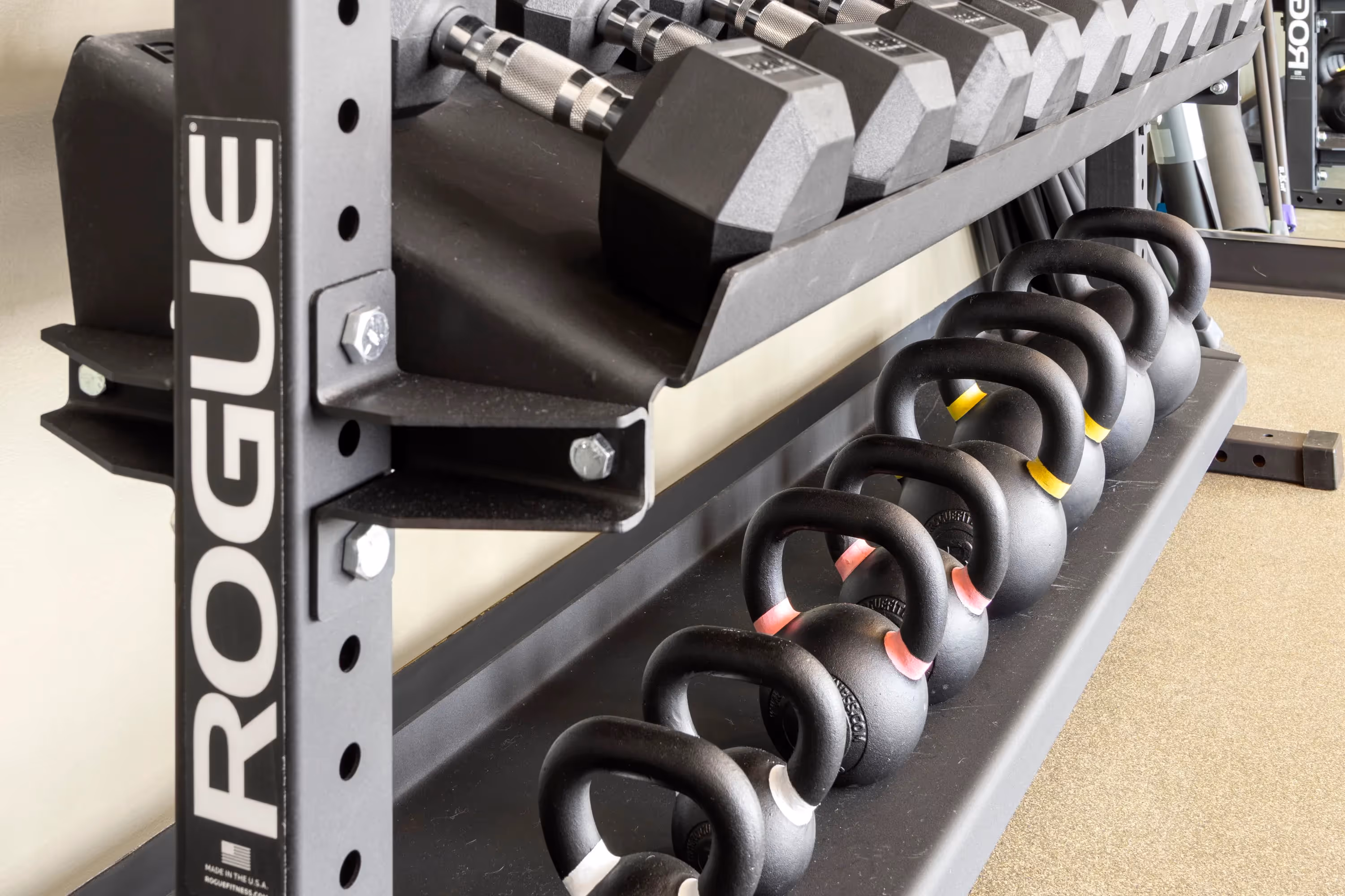 Expansive rooftop terrace at The Julian in Sloans Lake, Denver, at night, featuring multiple seating areas and stunning views of the illuminated city skyline.
