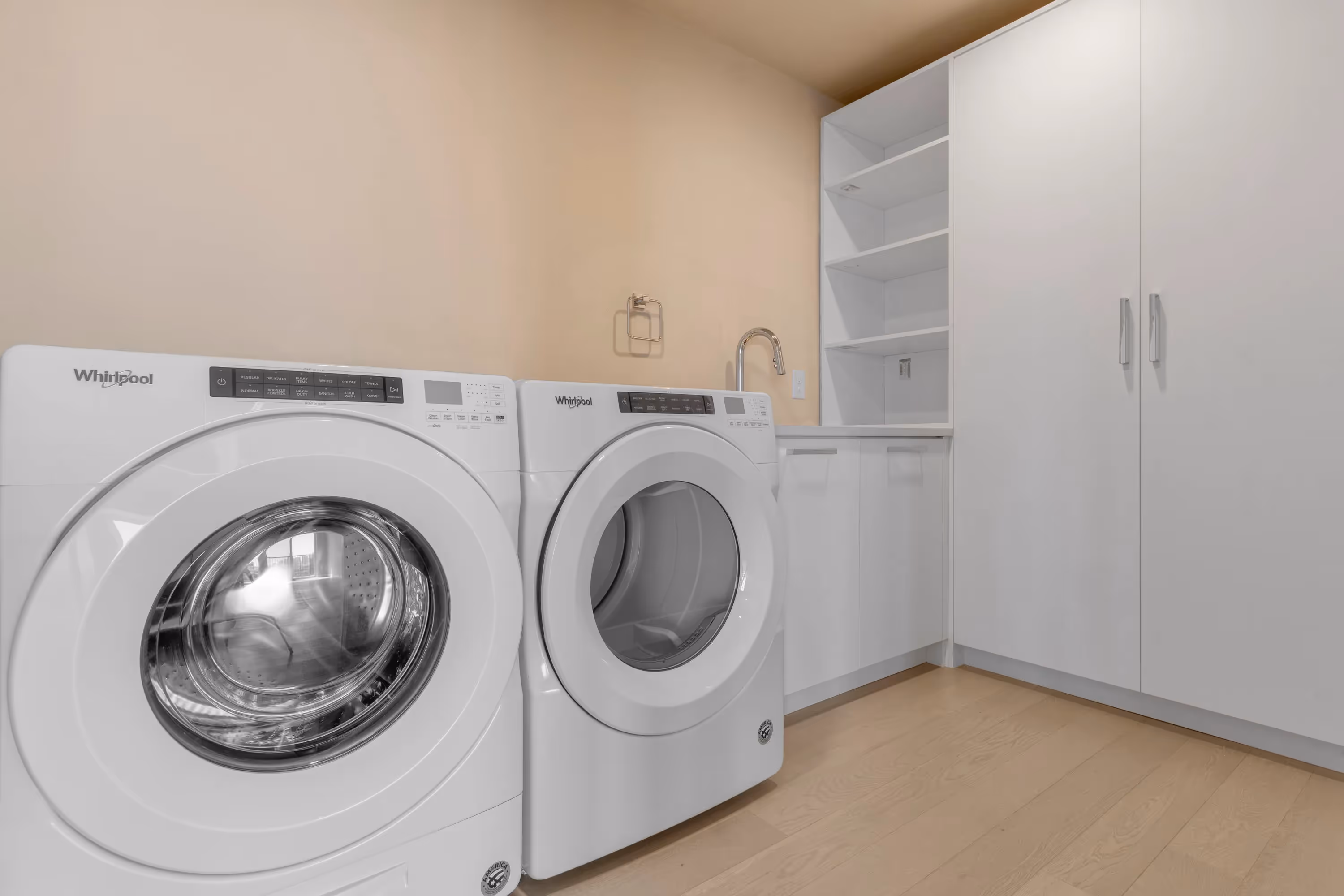 Stylish bedroom with a tufted headboard, modern bedding, and large window offering city views in a luxury apartment at The Julian, Sloans Lake, Denver.