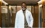 A doctor smiles at the camera