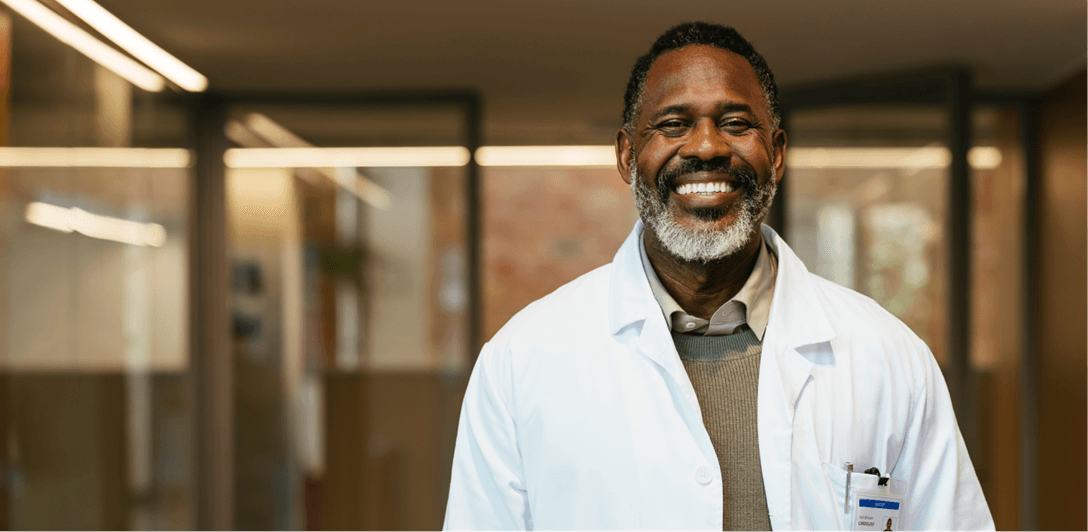 A doctor smiles and the camera 