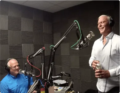 A picture of two people in a podcast setting