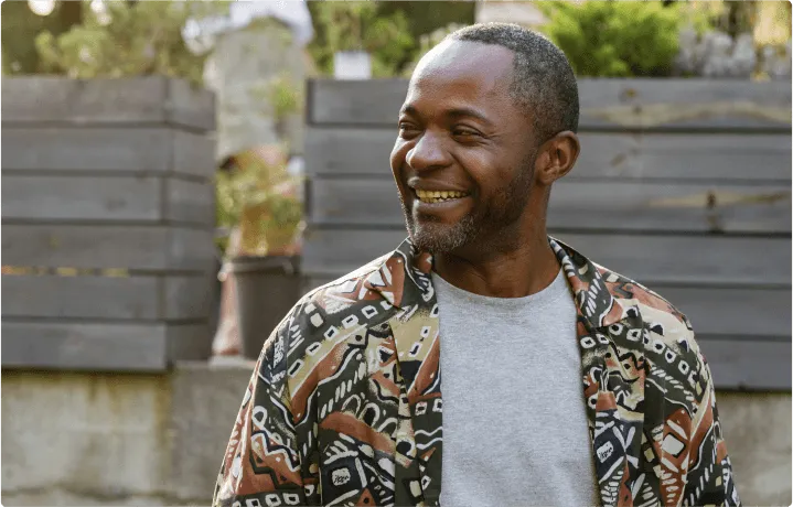 A man smiles at a spot far from the camera