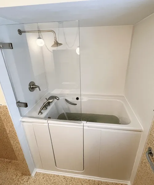 Elegant Kohler shower with premium fixtures and built-in shelving, perfect for a bathroom upgrade.