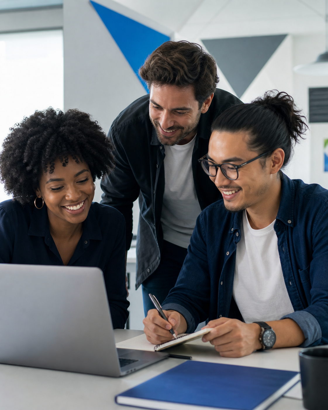 Diverse business professionals collaborating around a laptop and strategy notes