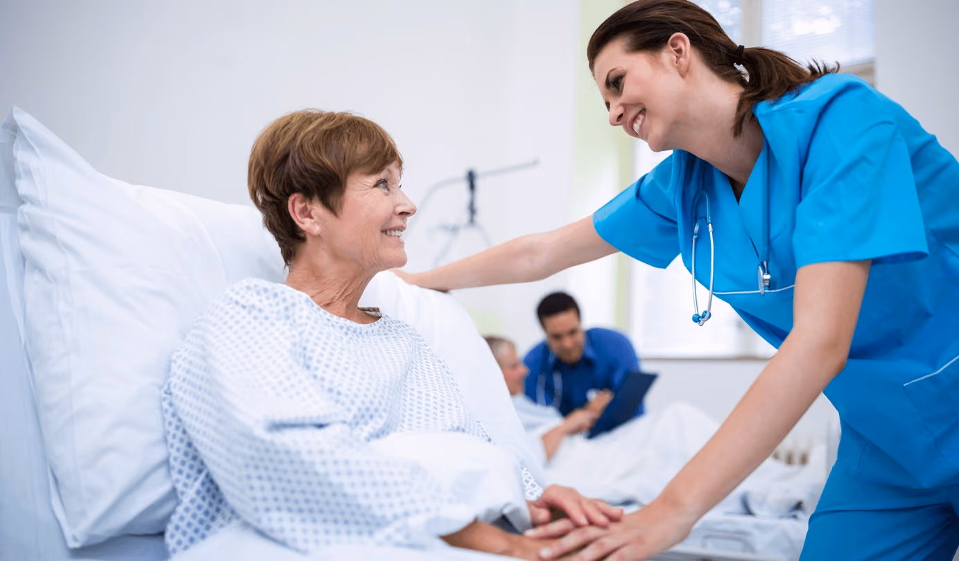 Preparing patient for anesthesia as a caring nurse assists a woman in a hospital bed, highlighting safe preoperative care by the best anesthesiologists in San Jose.