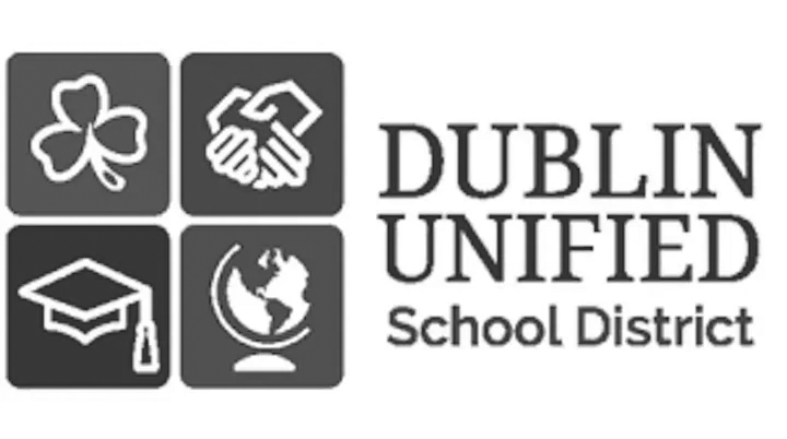 Dublin Unified School District logo with icons of a shamrock, handshake, graduation cap, and globe in dark squares.