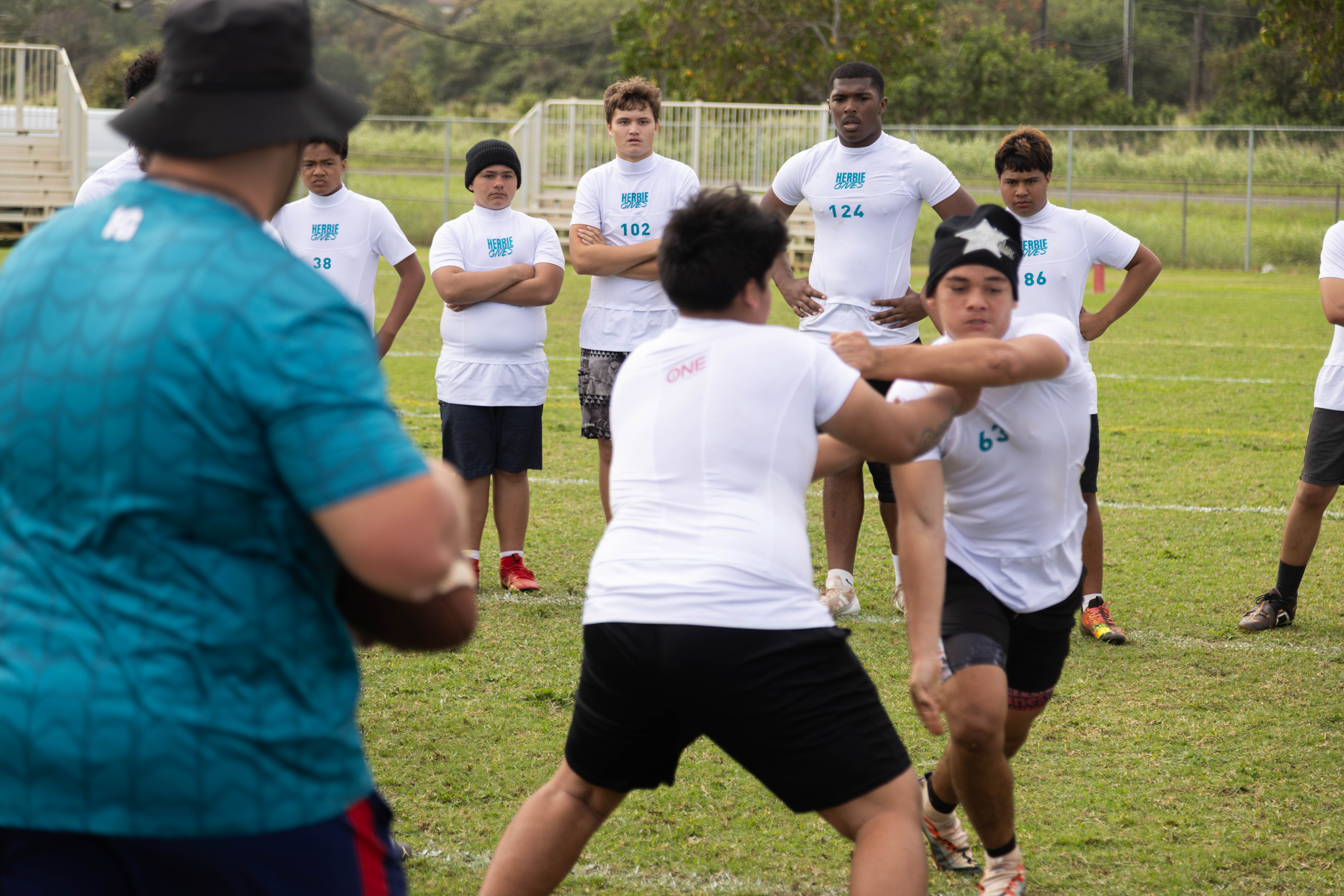 HerbieGives coach leading a drill with young athletes at camp