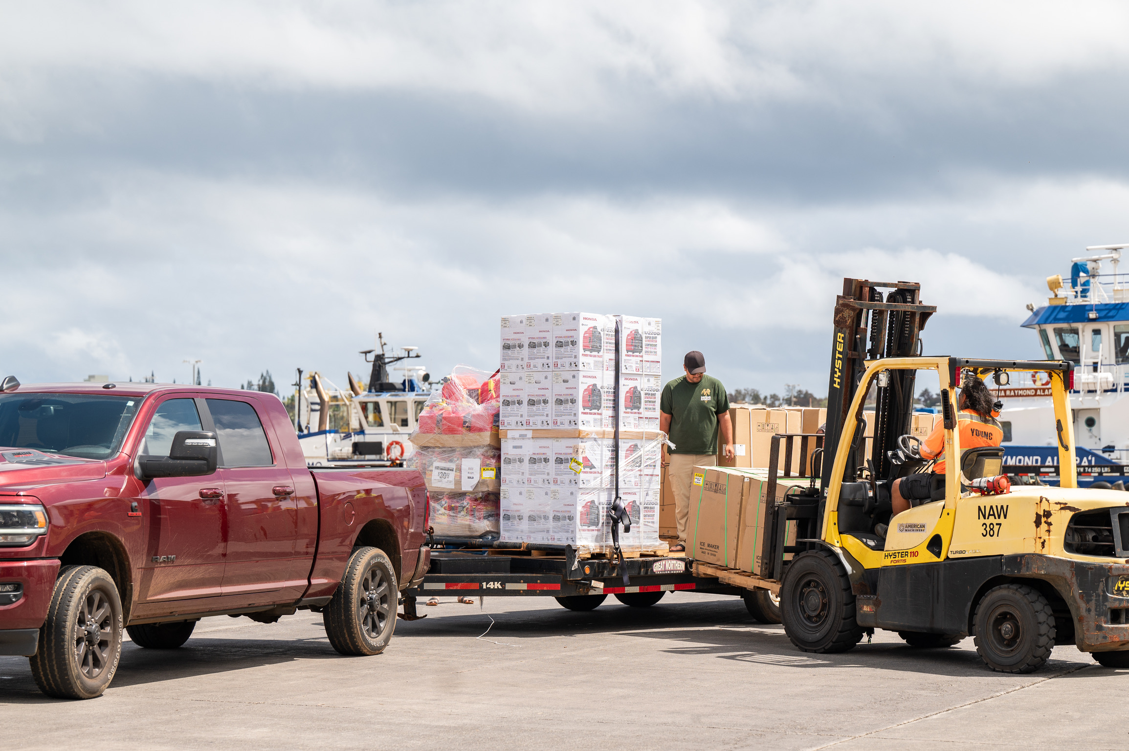 Forklift loading supplies onto a truck at the harbor