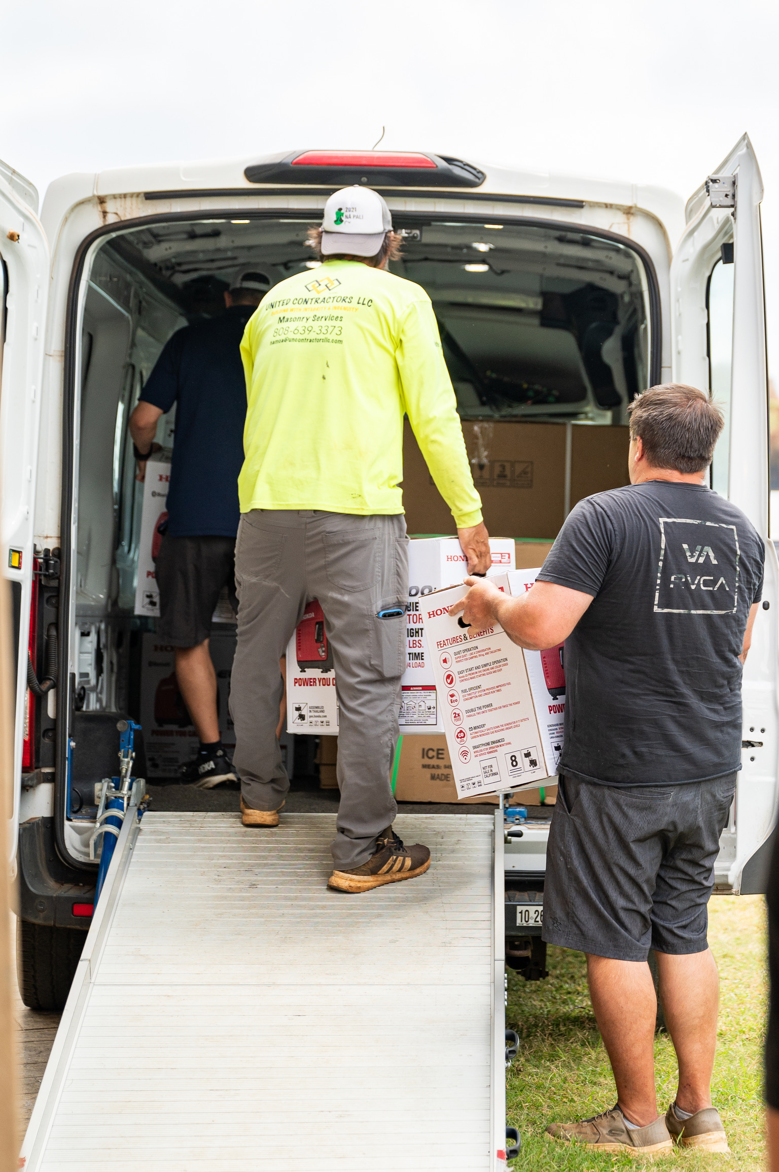 Volunteers unloading relief supplies from a van