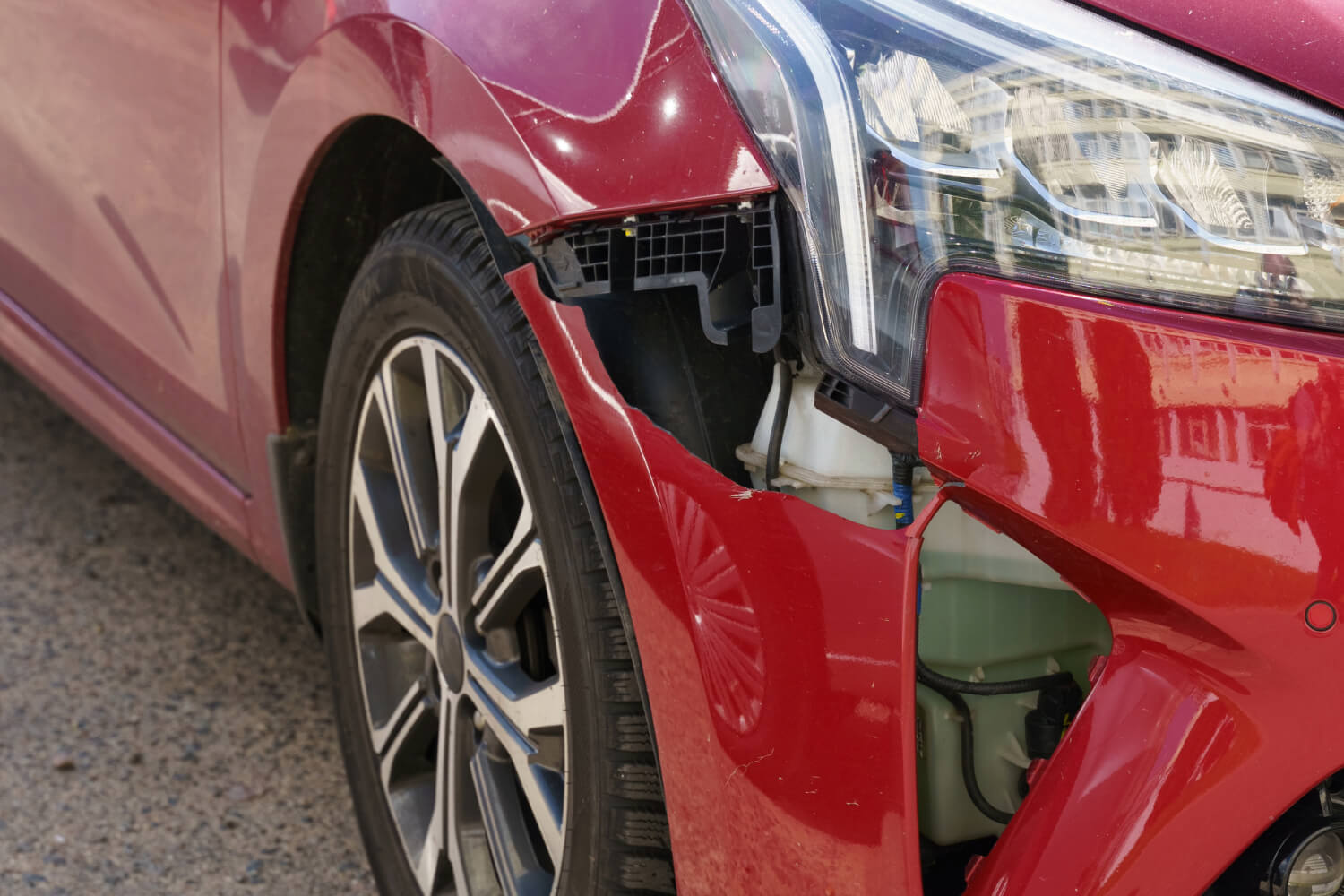Red car with front bumper damage