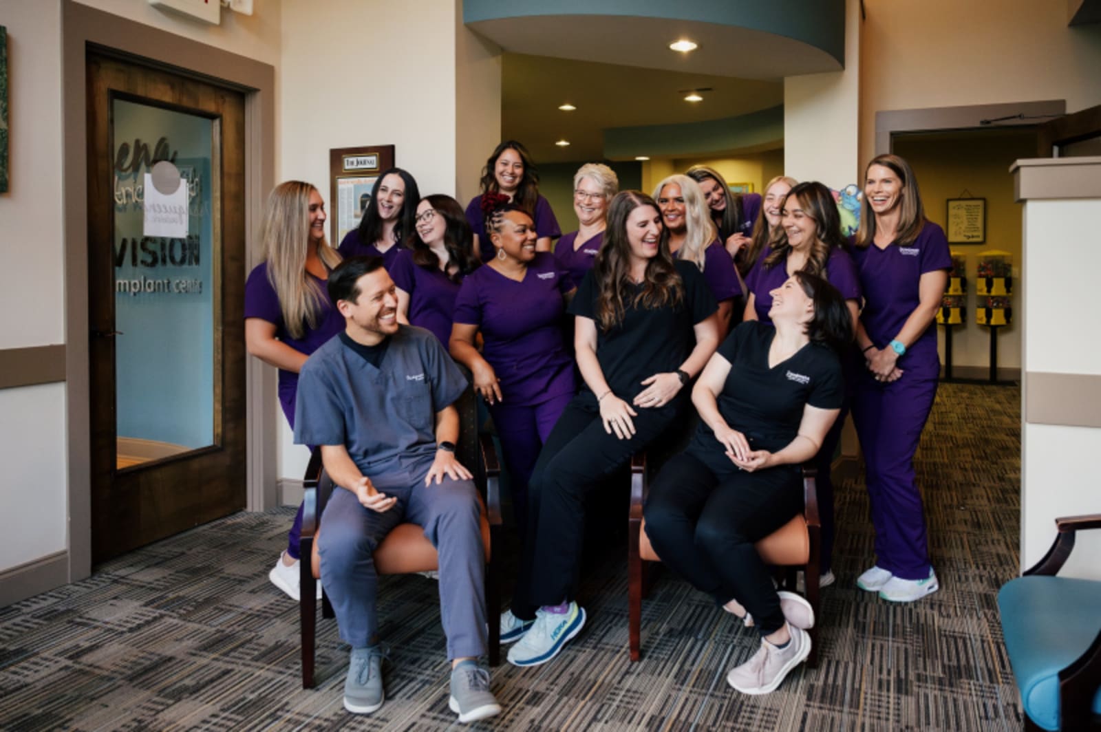 Team photo of Issaqueena Pediatric Dentistry staff in purple uniforms at Seneca location