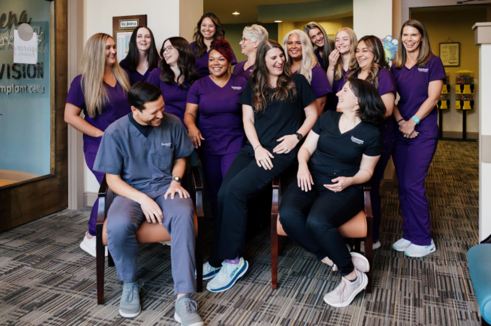 Diverse team of dental professionals in purple scrubs at Issaqueena Seneca location