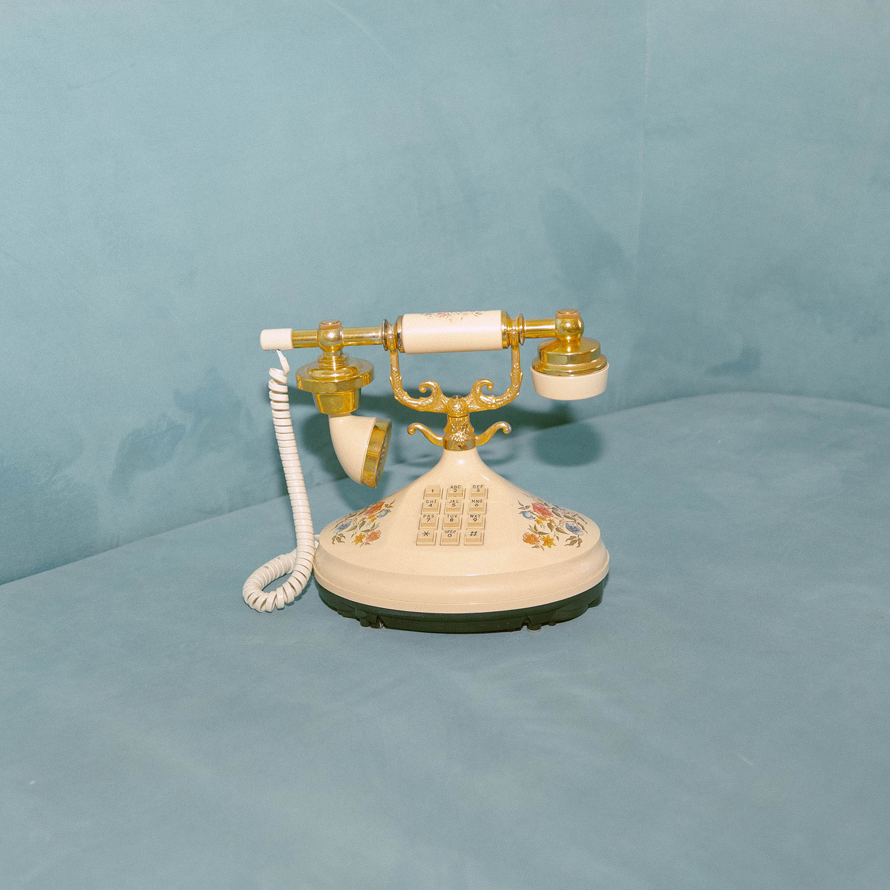 Old phone sitting on blue couch