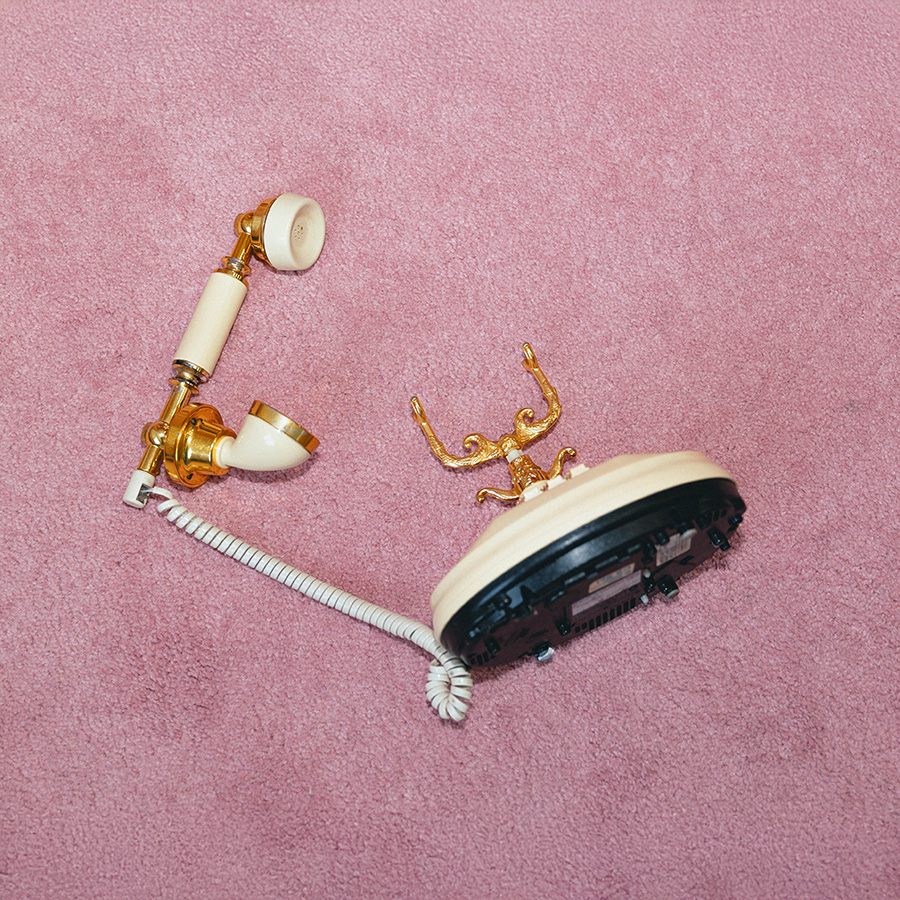 Old fashioned rotary phone on pink carpet