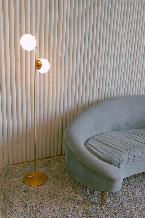 Blue couch in a blue room with a lamp