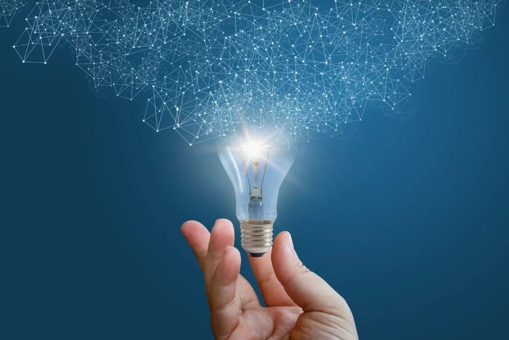 Photo of a hand holding a lightbulb