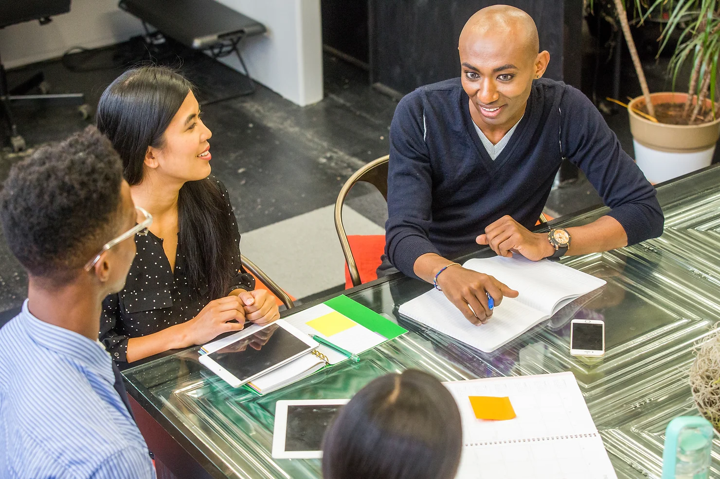 Photo of coworkers brainstorming behind a table