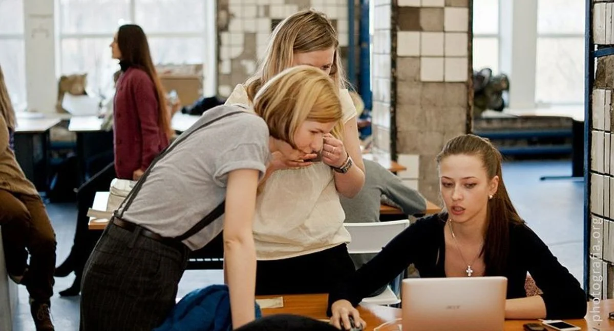 Photo of three coworkers discussing