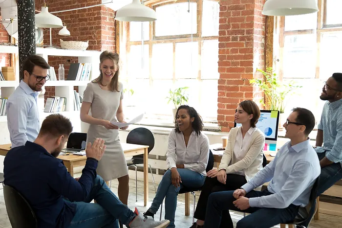 Photo of coworkers discussing and laughing