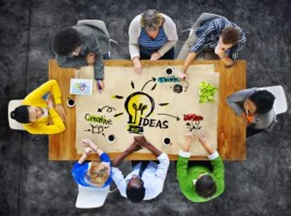 Photo from the ceiling of coworkers having a workshop