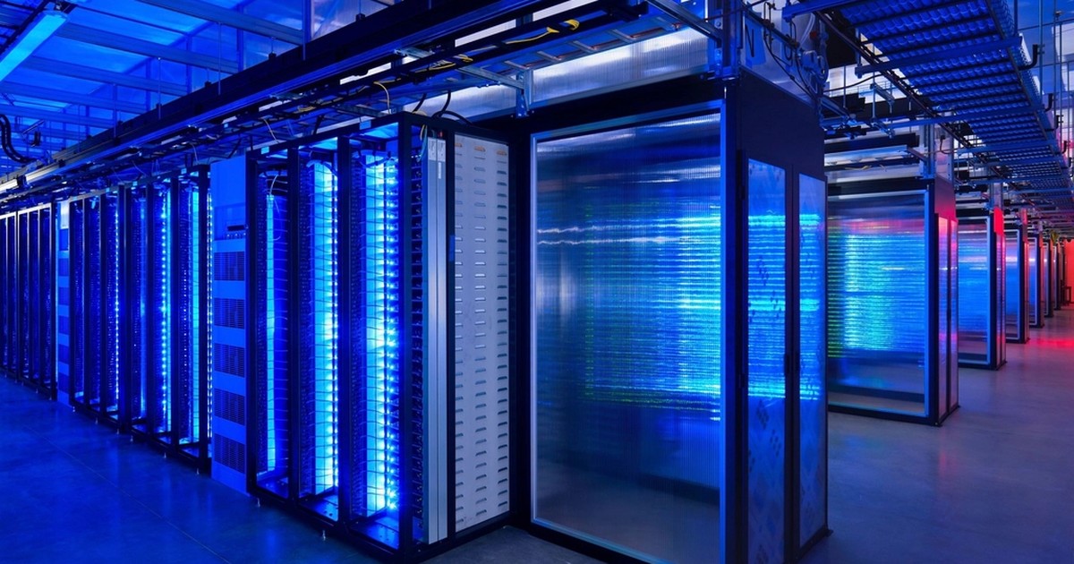 A modern data center with rows of illuminated blue server racks and cabling, the kind of network infrastructure agentic AI systems now operate inside.