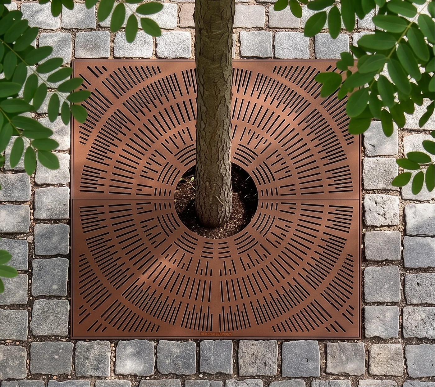 Tree grate set into cobblestone paving