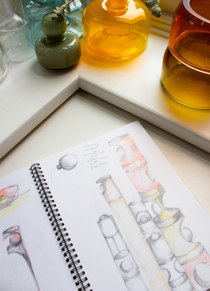 there are a bunch of glasses and a notebook on a table