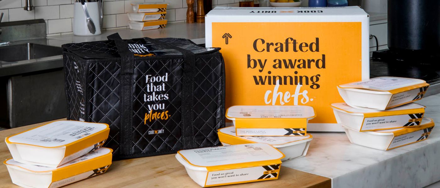 CookUnity B2B delivery boxes arriving at a Project 180 housing site, showcasing the organized, scalable logistics of the kitchenless meal program for large-scale social service organizations.