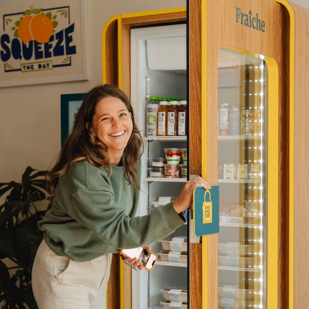 Woman using a smart fridge in a residential building