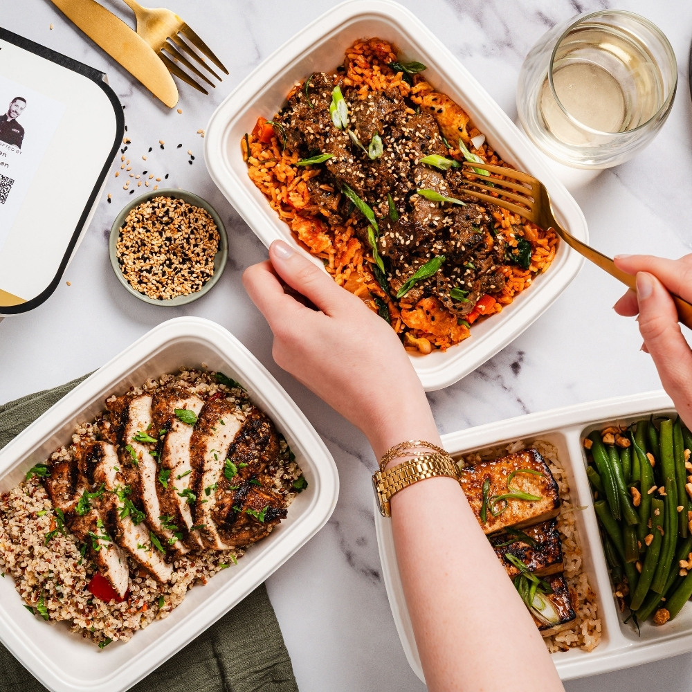 Residents eating cookunity meals from a smart fridge in an apartment building