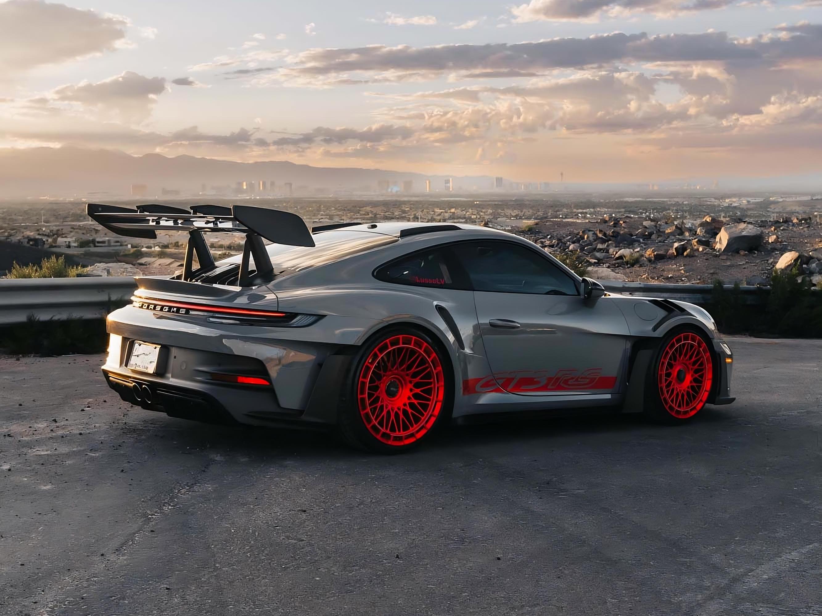 Black Porsche overlooking Las Vegas at golden hour