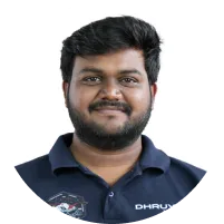 Headshot of a smiling man with dark hair and beard wearing a navy blue polo shirt against a white background.