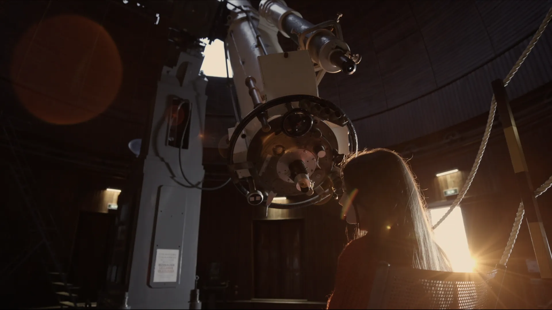 Jeune femme sous le télescope d'un observatoire, film de marque Norman's Lab