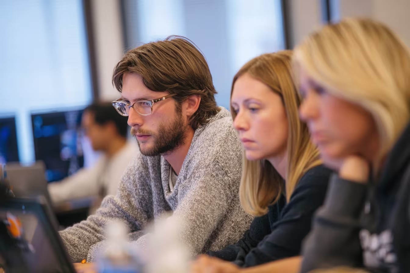 Employees collaborating on anti-phishing solutions