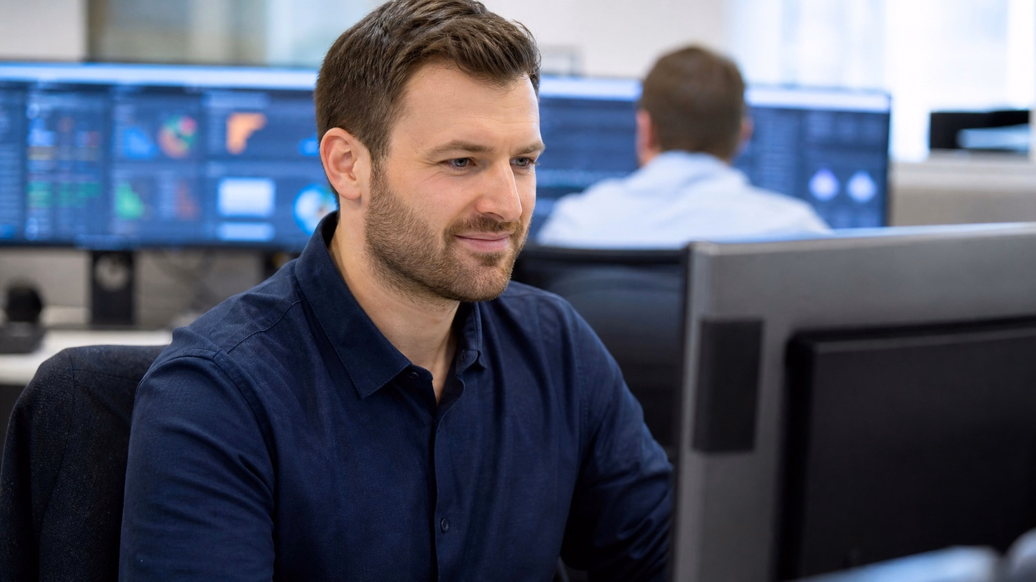 Financial IT consultant analyzes complex data charts on screen