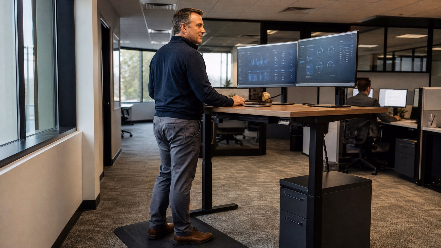 IT manager reviews vendor compliance report at standing desk