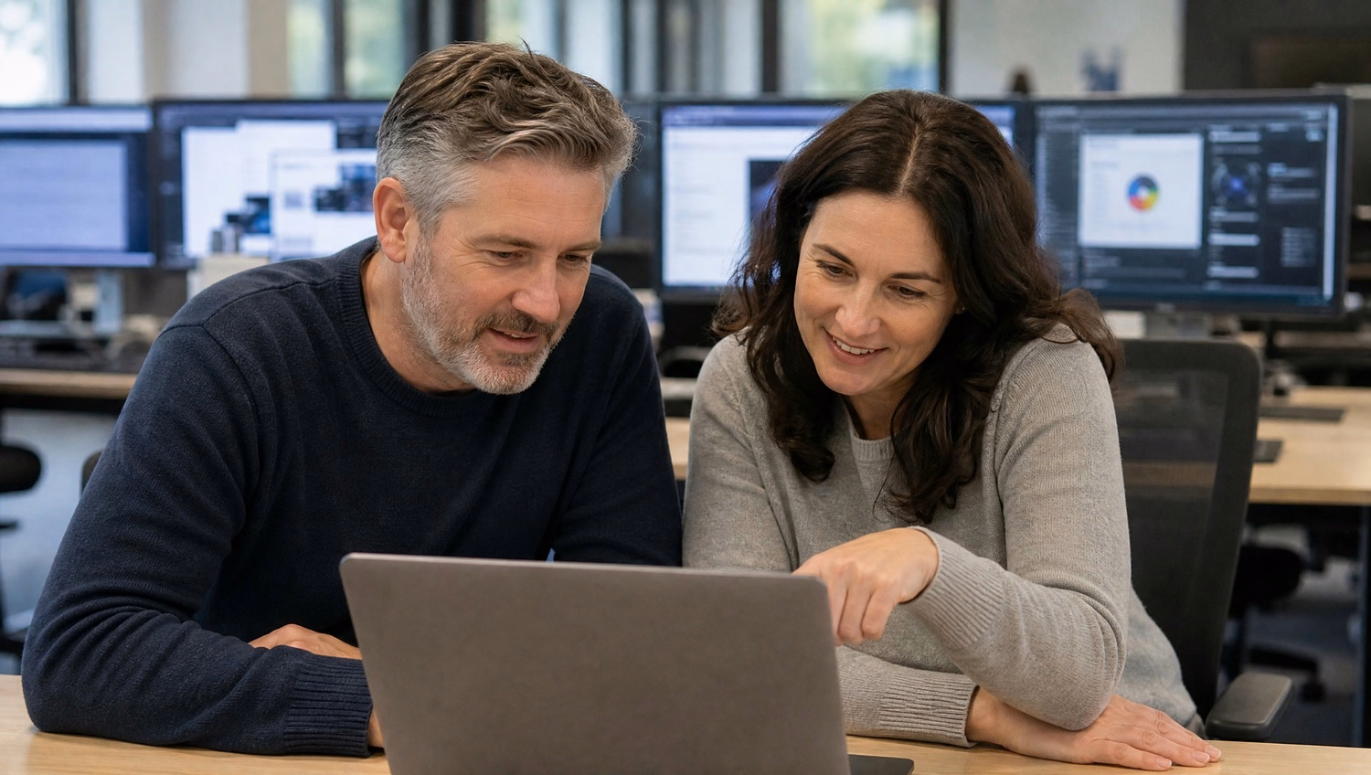 Man and woman review risk assessment report on laptop 74