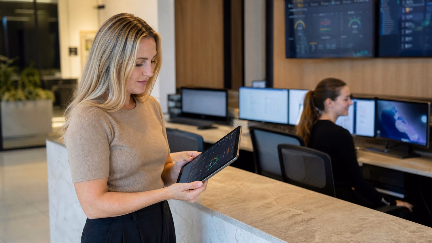 Woman checks network status on tablet at reception desk