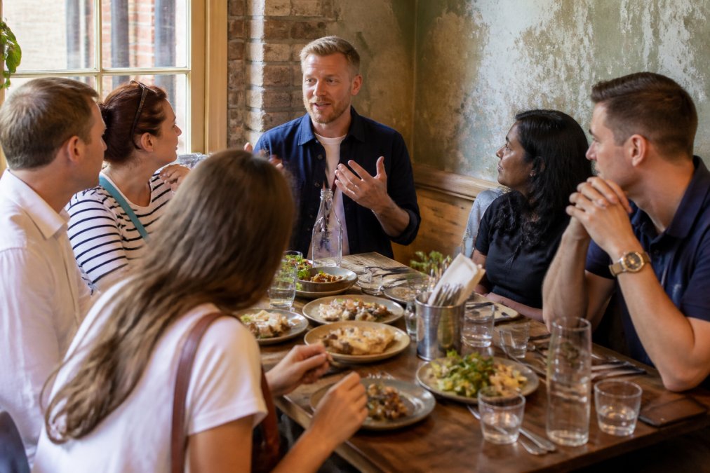 Infographic process flow for a guided culinary tour in a Manchester eatery featuring shared regional dishes