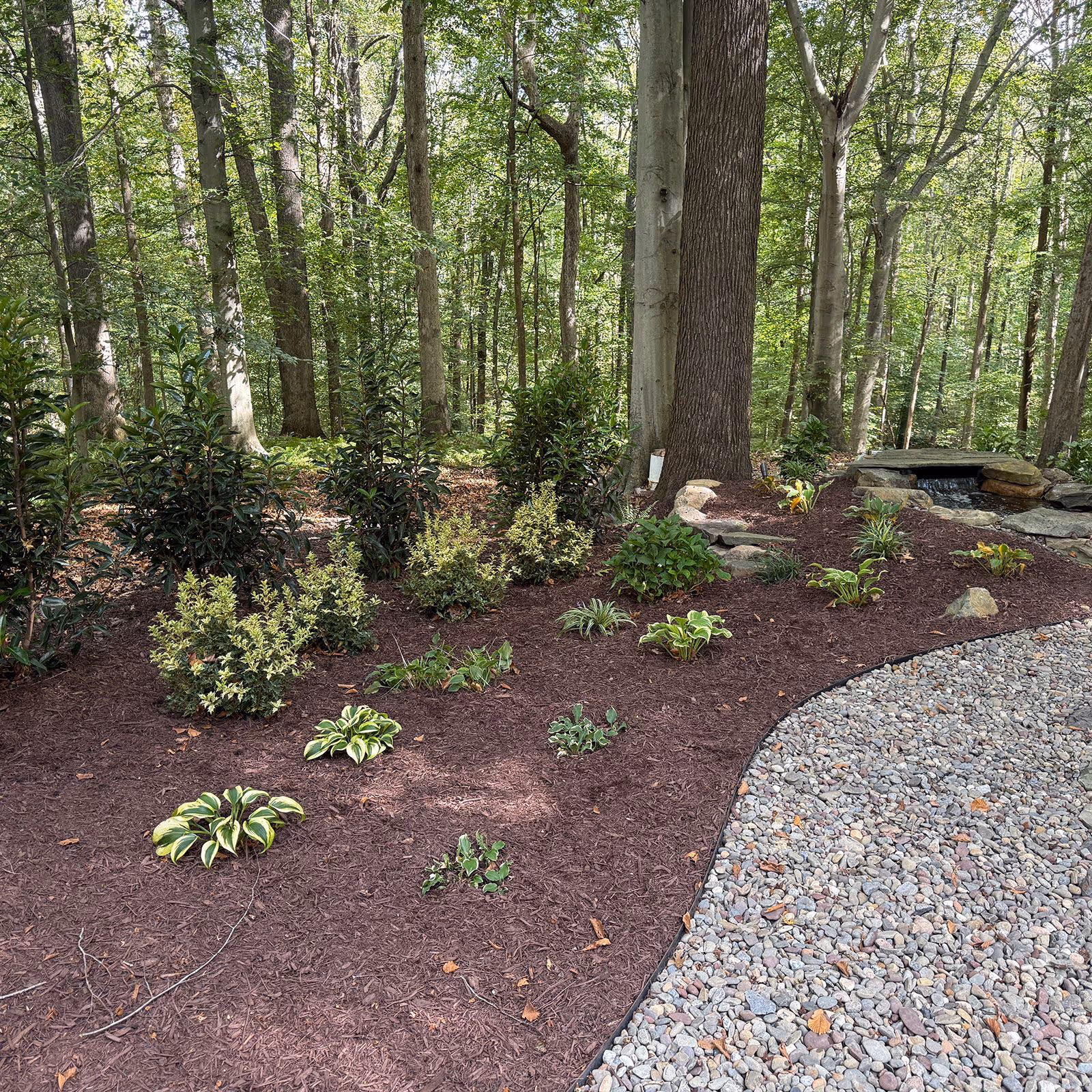 Beautiful garden with new mulch and plants by Larsen's Lawn and Landscape.